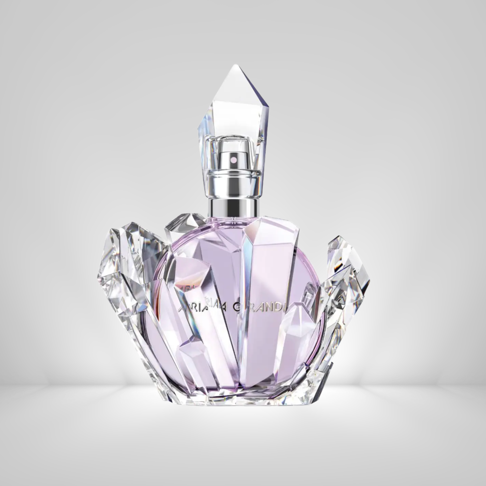Ariana Grande REM Eau De Parfum Crystal perfume bottle with a geometric design on a light gray background